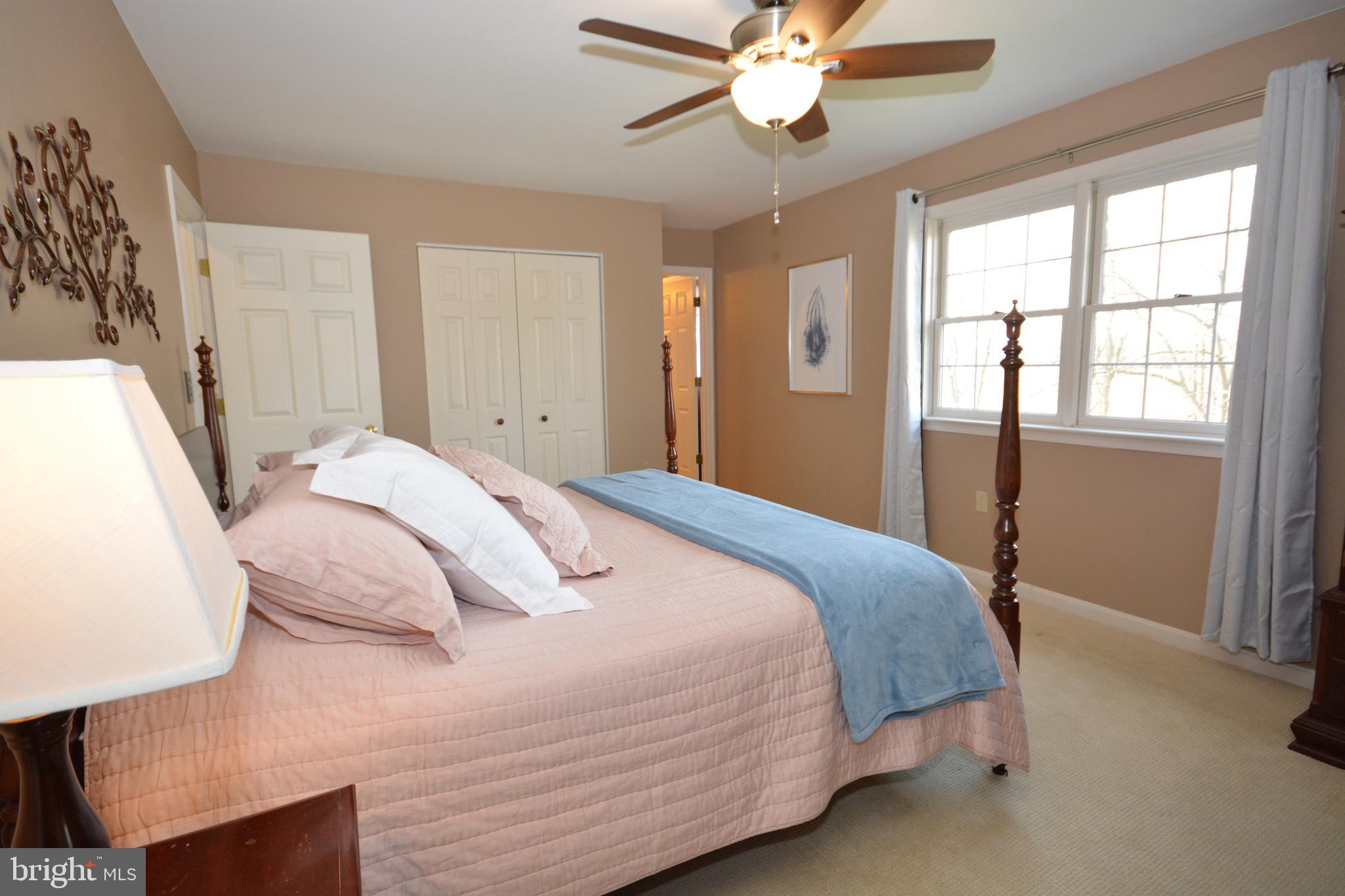 213 Bomberger Road Akron, PA 17501 - Photo 21 of 38 a bedroom with a large bed and a chandelier