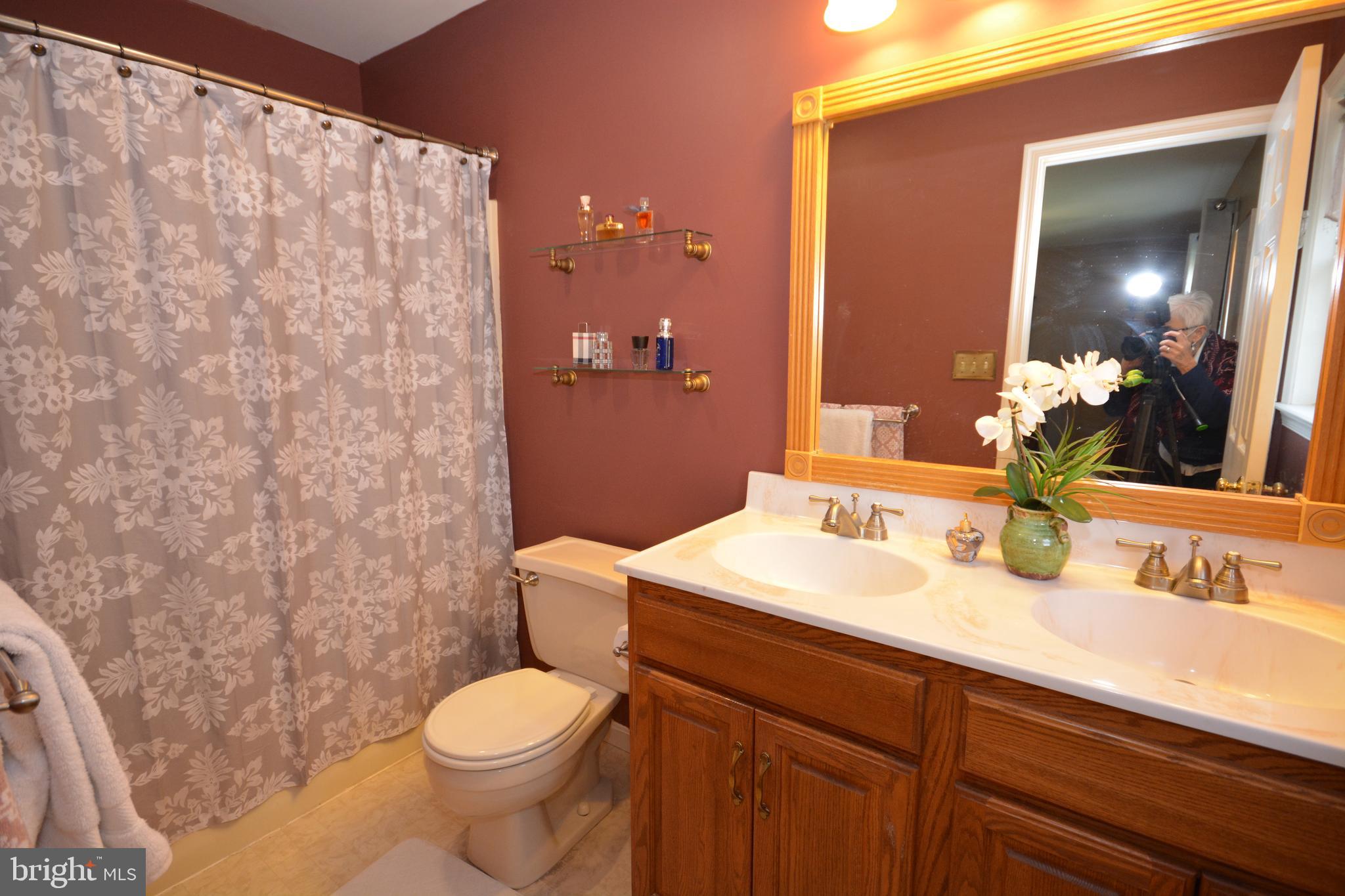 213 Bomberger Road Akron, PA 17501 - Photo 22 of 38 a bathroom with a sink a toilet and a mirror