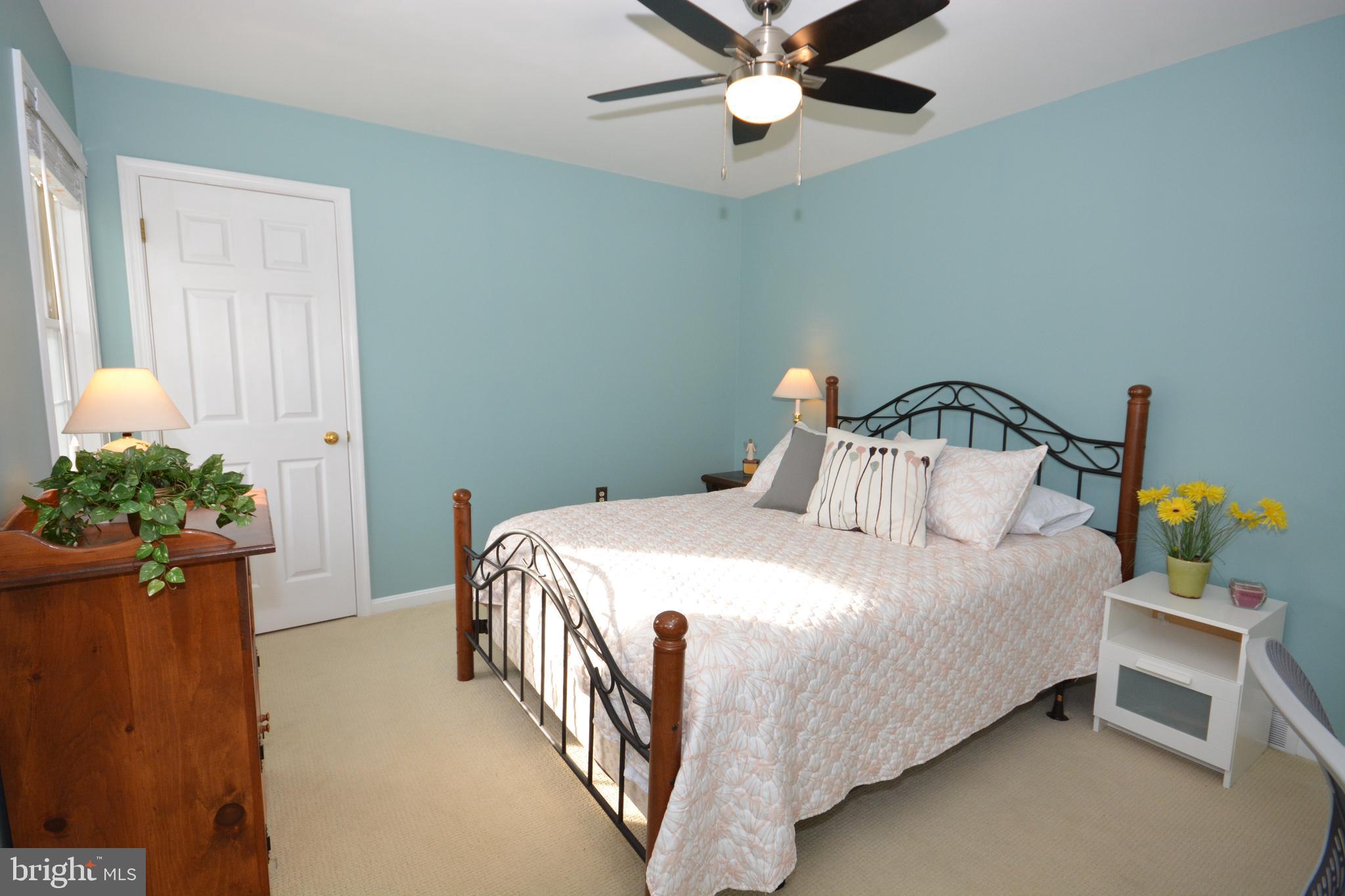 213 Bomberger Road Akron, PA 17501 - Photo 23 of 38 a bedroom with a bed and ceiling fan