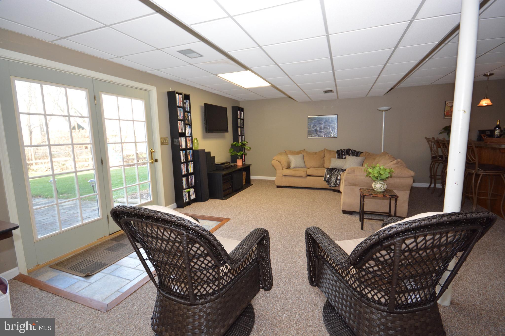 213 Bomberger Road Akron, PA 17501 - Photo 25 of 38 a dining room with furniture a rug a potted plant and a chandelier
