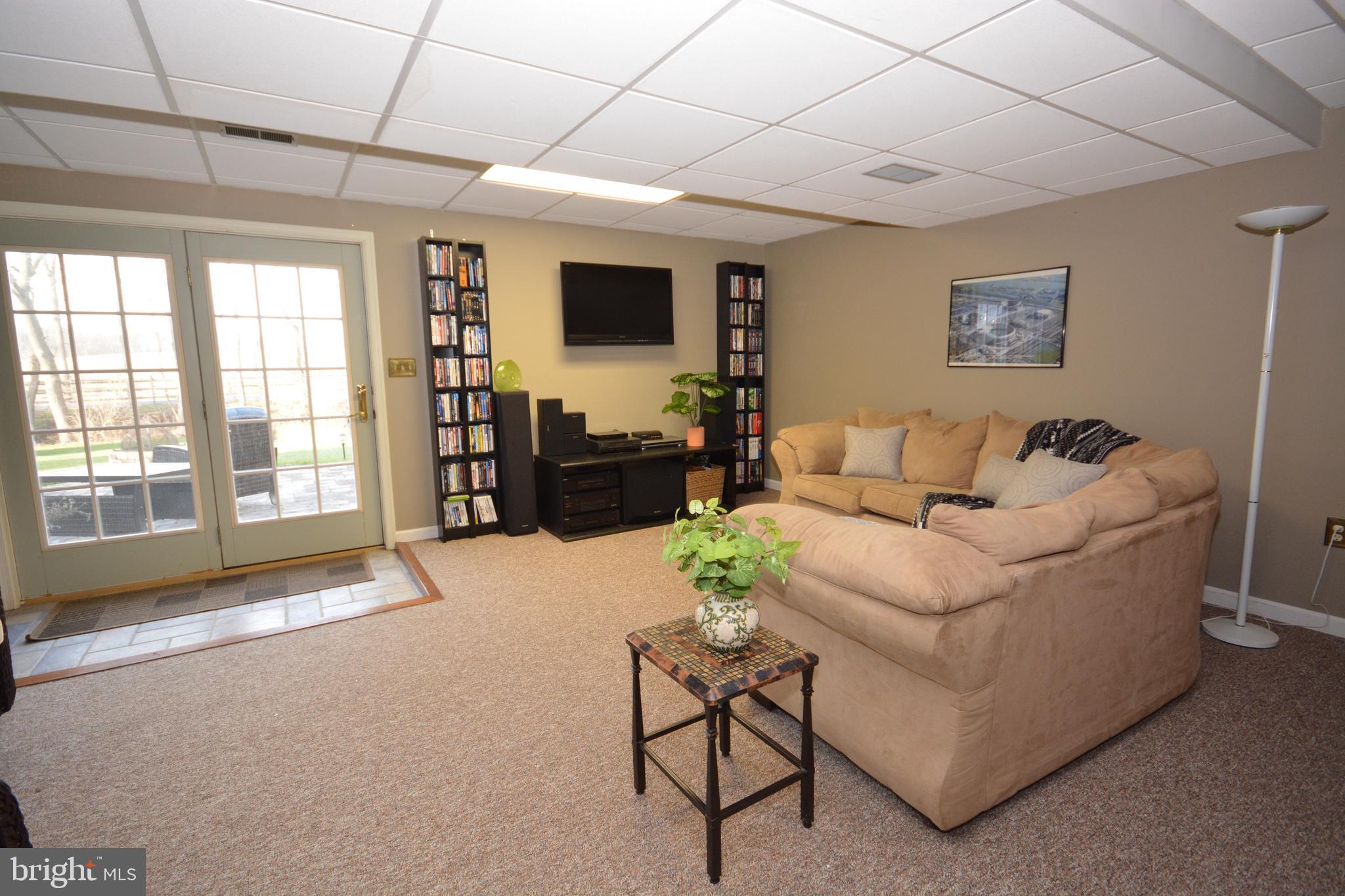 213 Bomberger Road Akron, PA 17501 - Photo 27 of 38 a living room with furniture and a flat screen tv