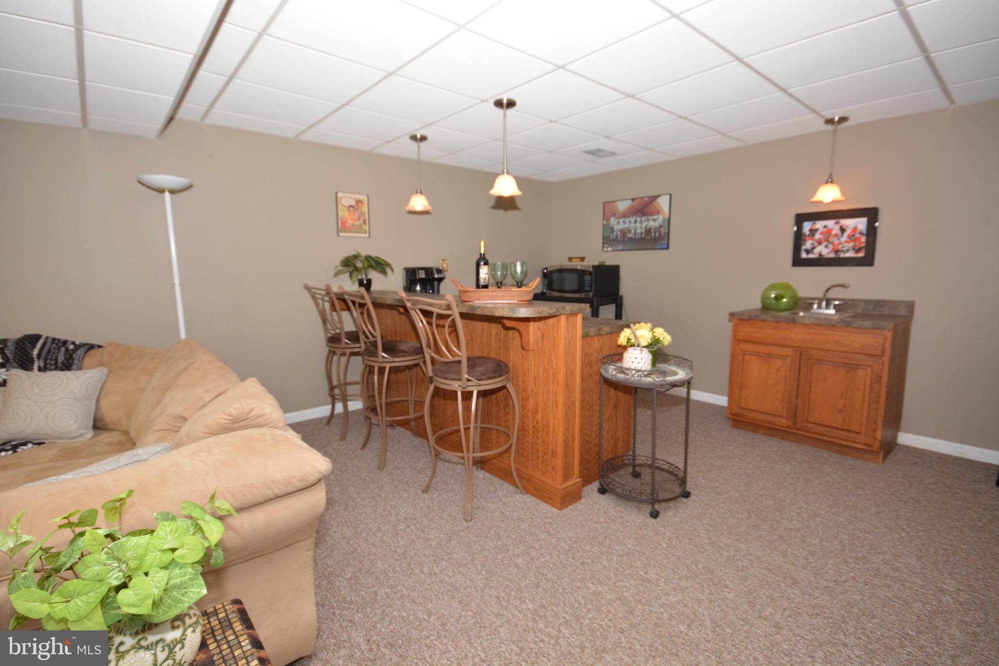 213 Bomberger Road Akron, PA 17501 - Photo 28 of 38 a living room with furniture a chandelier and a dining table