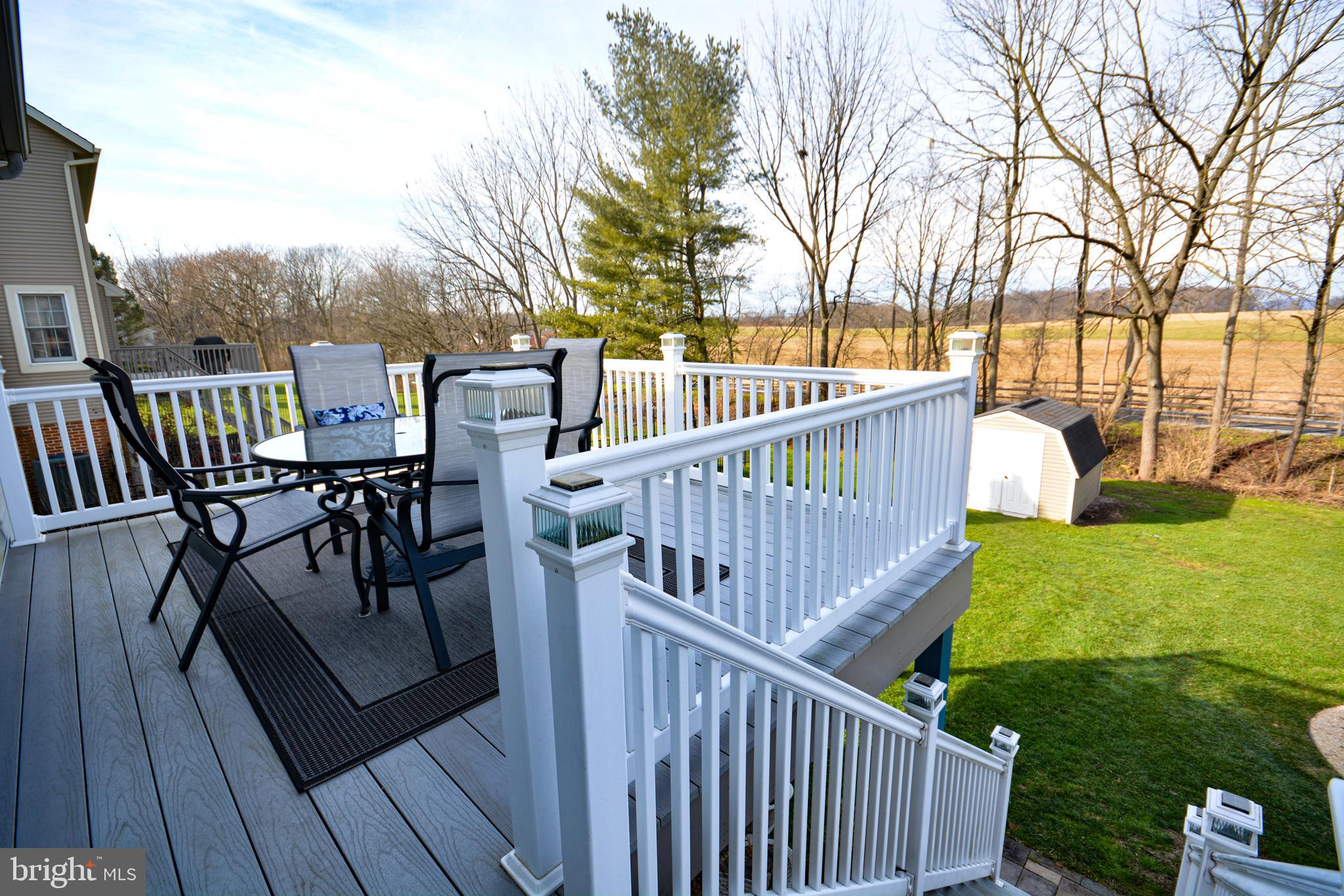 213 Bomberger Road Akron, PA 17501 - Photo 33 of 38 a view of a deck with chairs and wooden floor and fence