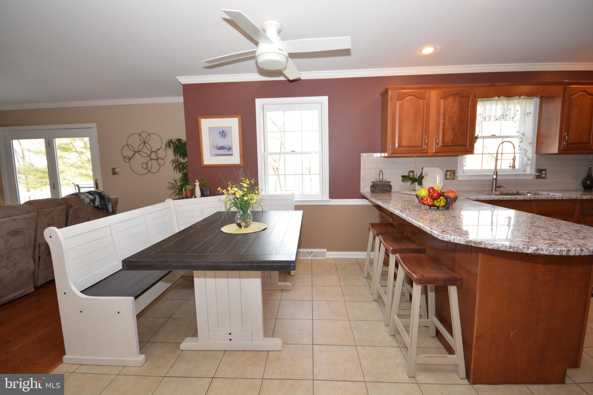 213 Bomberger Road Akron, PA 17501 - Photo 8 of 38 a kitchen with a sink a stove a dining table and chairs