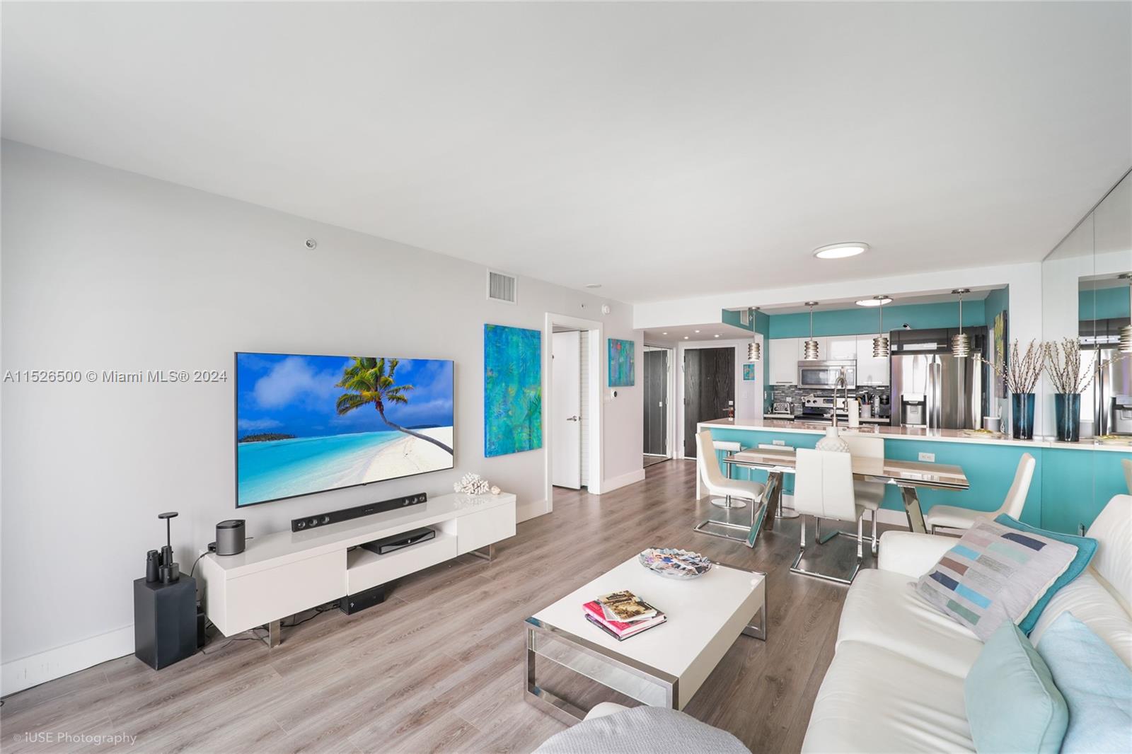 90 Alton Road, Unit 2806 Miami Beach, FL 33139 - Photo 11 of 18 a living room with furniture and a wooden floor