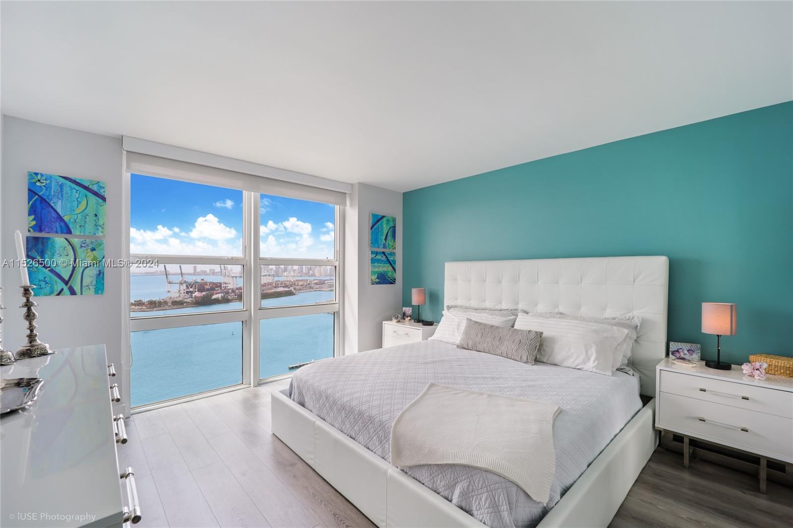 90 Alton Road, Unit 2806 Miami Beach, FL 33139 - Photo 12 of 18 a large white bed in a room next to a window