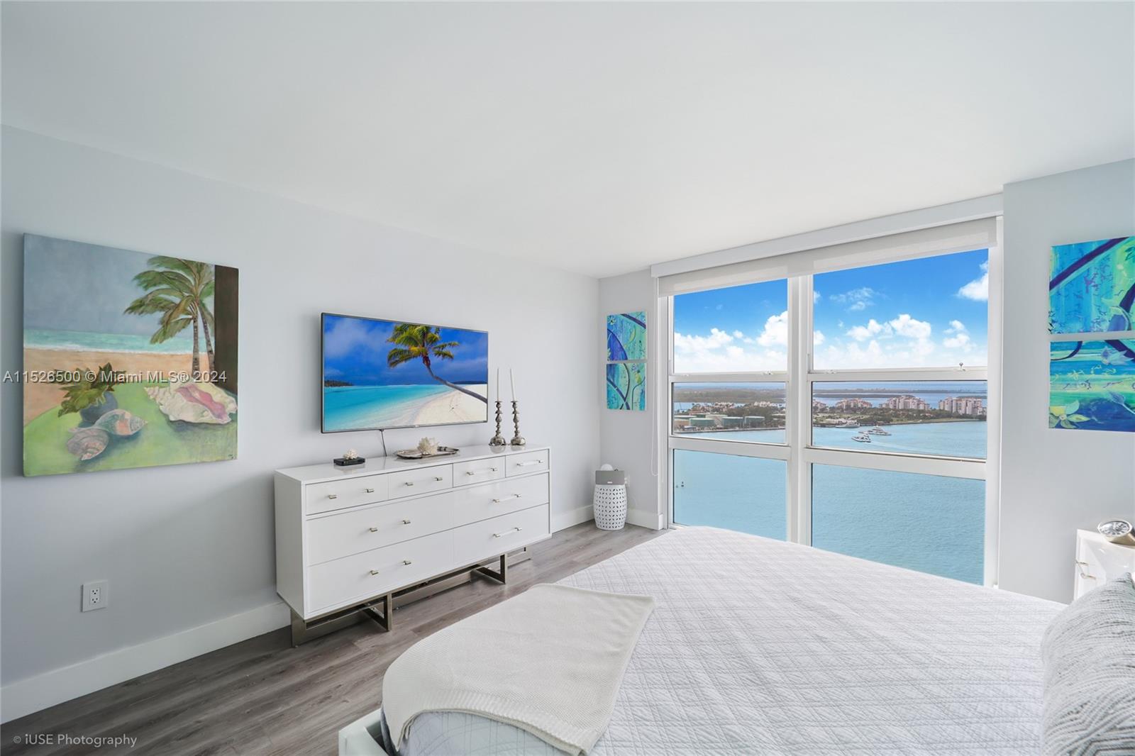 90 Alton Road, Unit 2806 Miami Beach, FL 33139 - Photo 13 of 18 a bedroom with a bed and a dresser