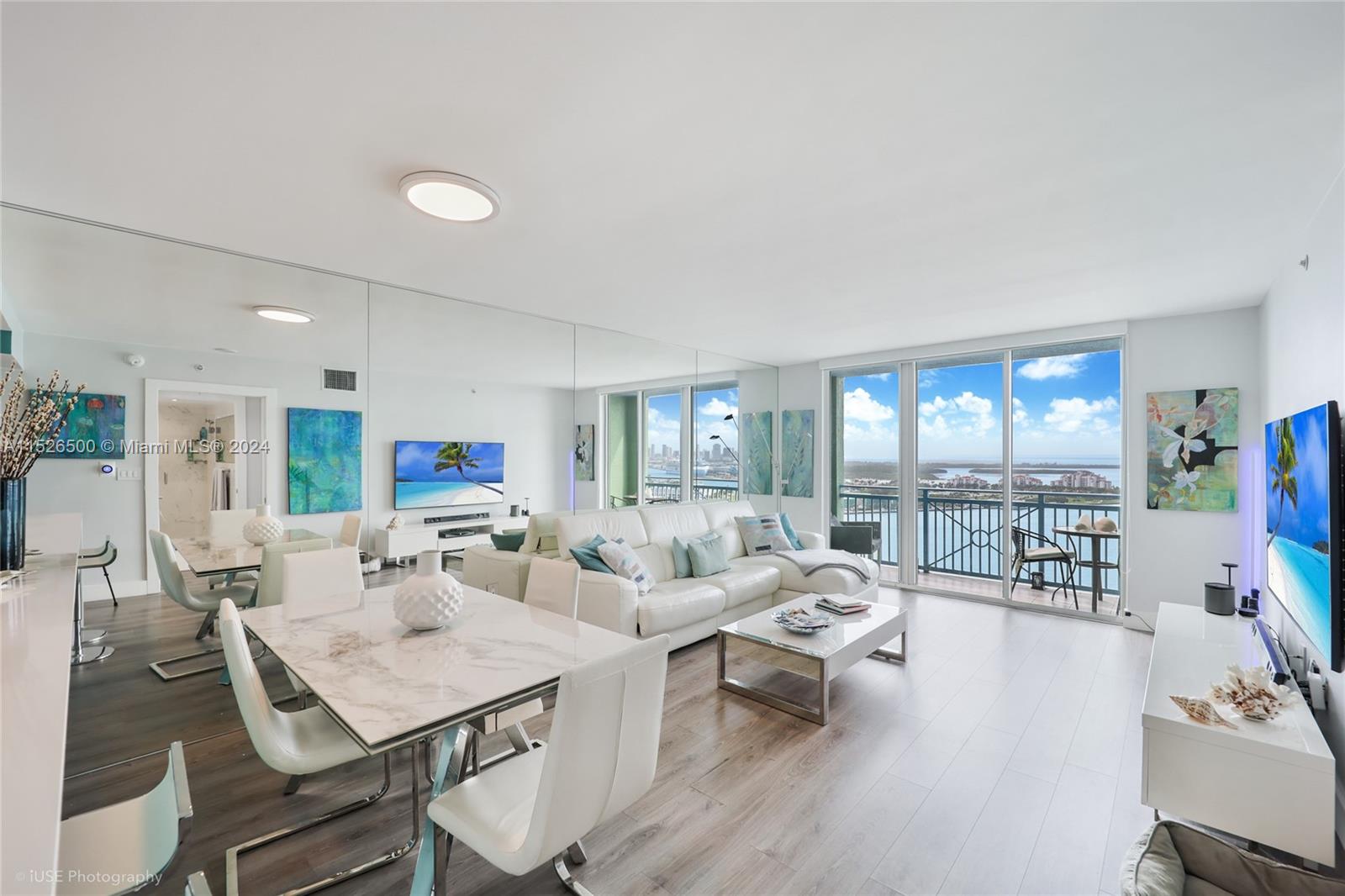 90 Alton Road, Unit 2806 Miami Beach, FL 33139 - Photo 3 of 18 a living room with furniture and a large window