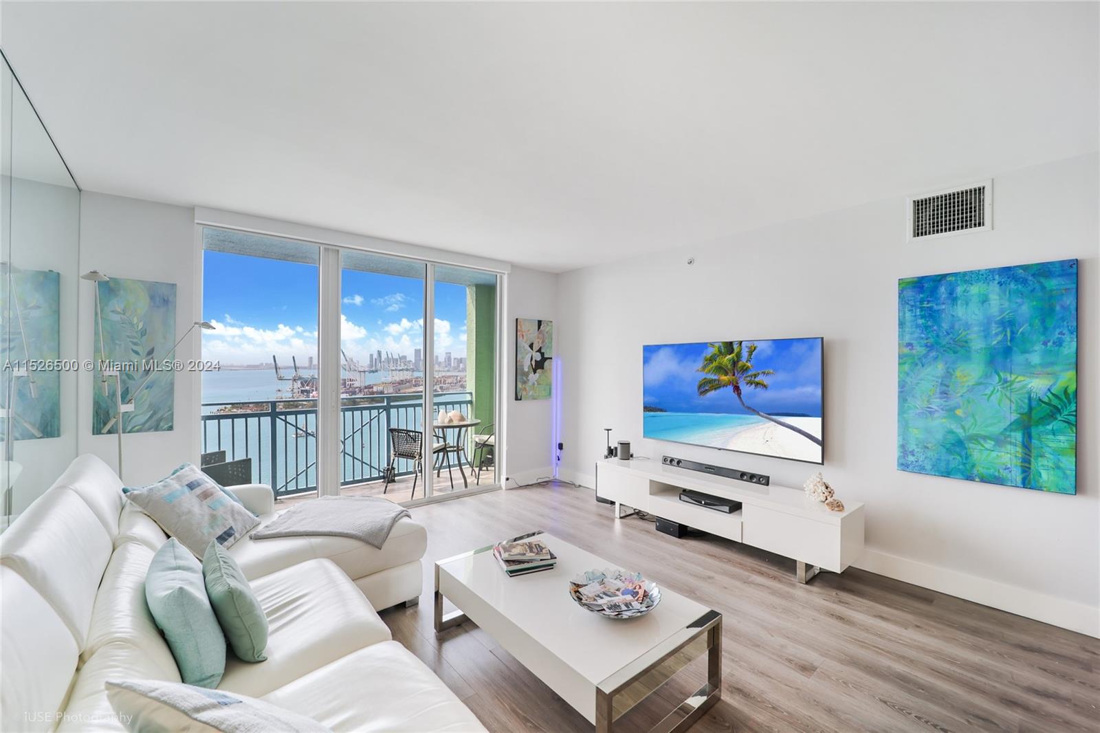 90 Alton Road, Unit 2806 Miami Beach, FL 33139 - Photo 4 of 18 a living room with furniture and a flat screen tv