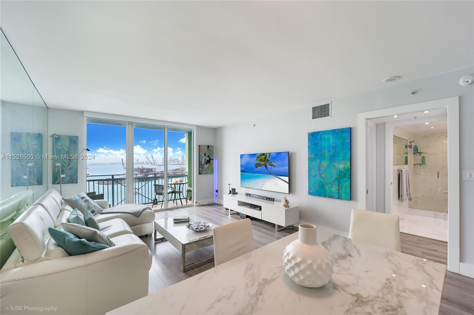 90 Alton Road, Unit 2806 Miami Beach, FL 33139 - Photo 8 of 18 a living room with furniture window and a flat screen tv