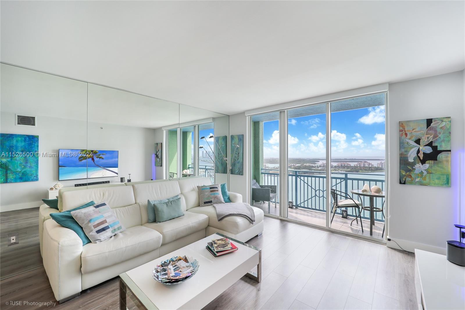 90 Alton Road, Unit 2806 Miami Beach, FL 33139 - Photo 9 of 18 a living room with furniture and a large window