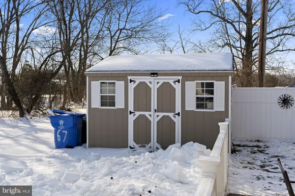 a view of a house with a yard covered in snow