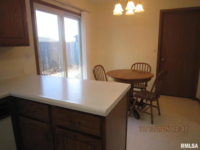 a view of a chairs and table in the balcony