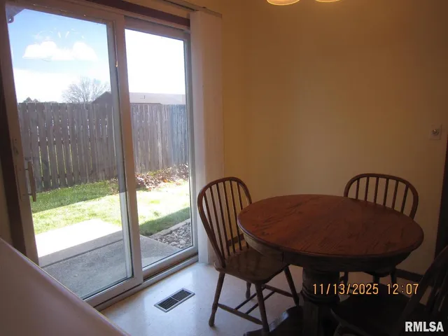 a view of a dining room with furniture and window