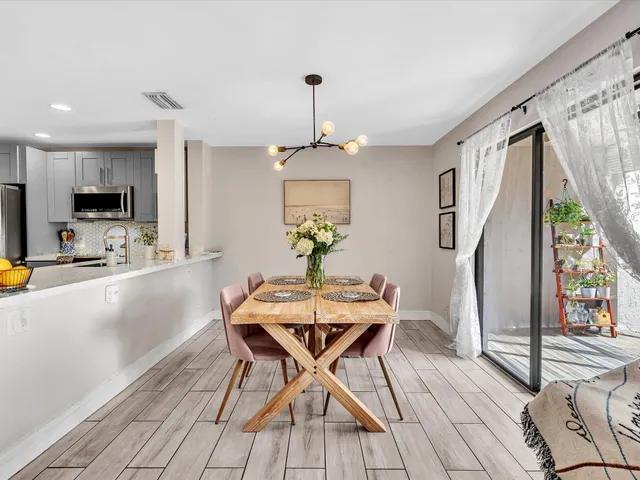 a living room with furniture a rug and a chandelier