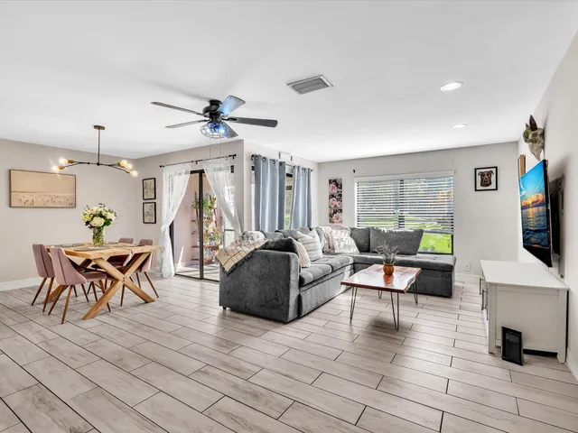 a view of a livingroom with furniture and a flat screen tv