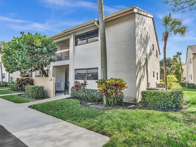 a view of a hallway with wooden floor windows and a livingroom