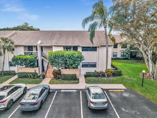 a living room with lots of furniture and view of kitchen