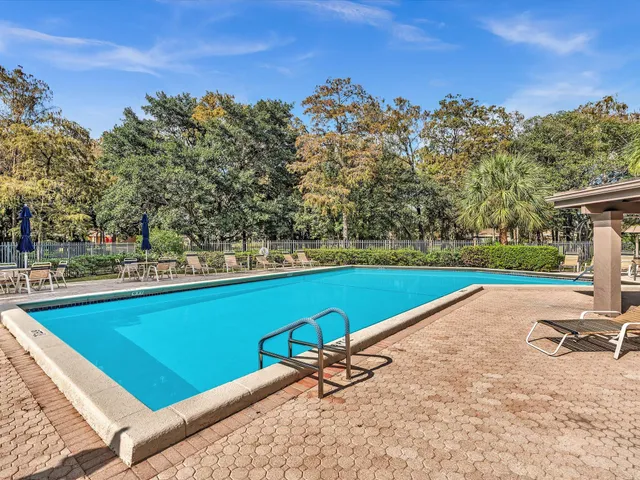 an aerial view of a house with a yard and tennis court