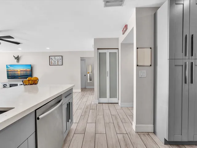a kitchen with stainless steel appliances a stove a sink and a refrigerator