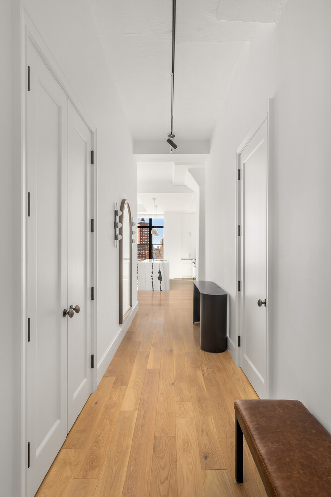 143 Reade Street, Unit 10A Manhattan, NY 10013 - Photo 13 of 18 a view of a hallway with wooden floor and furniture