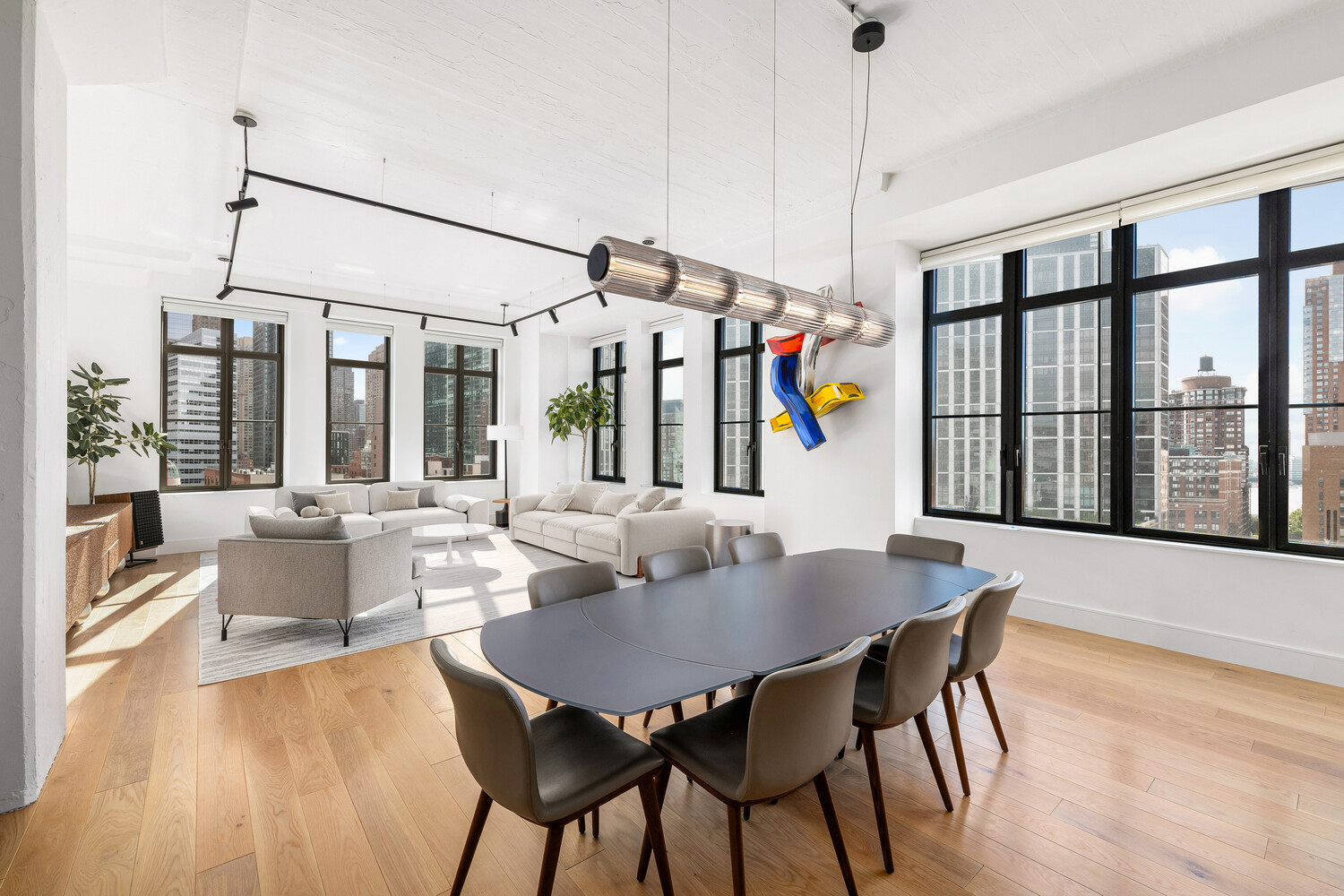143 Reade Street, Unit 10A Manhattan, NY 10013 - Photo 3 of 18 a view of a dining room with furniture wooden floor and chandelier