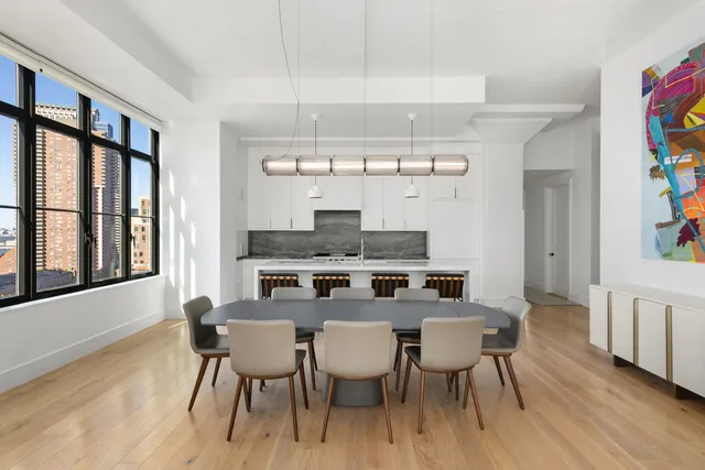 a view of a dining room with furniture wooden floor and chandelier