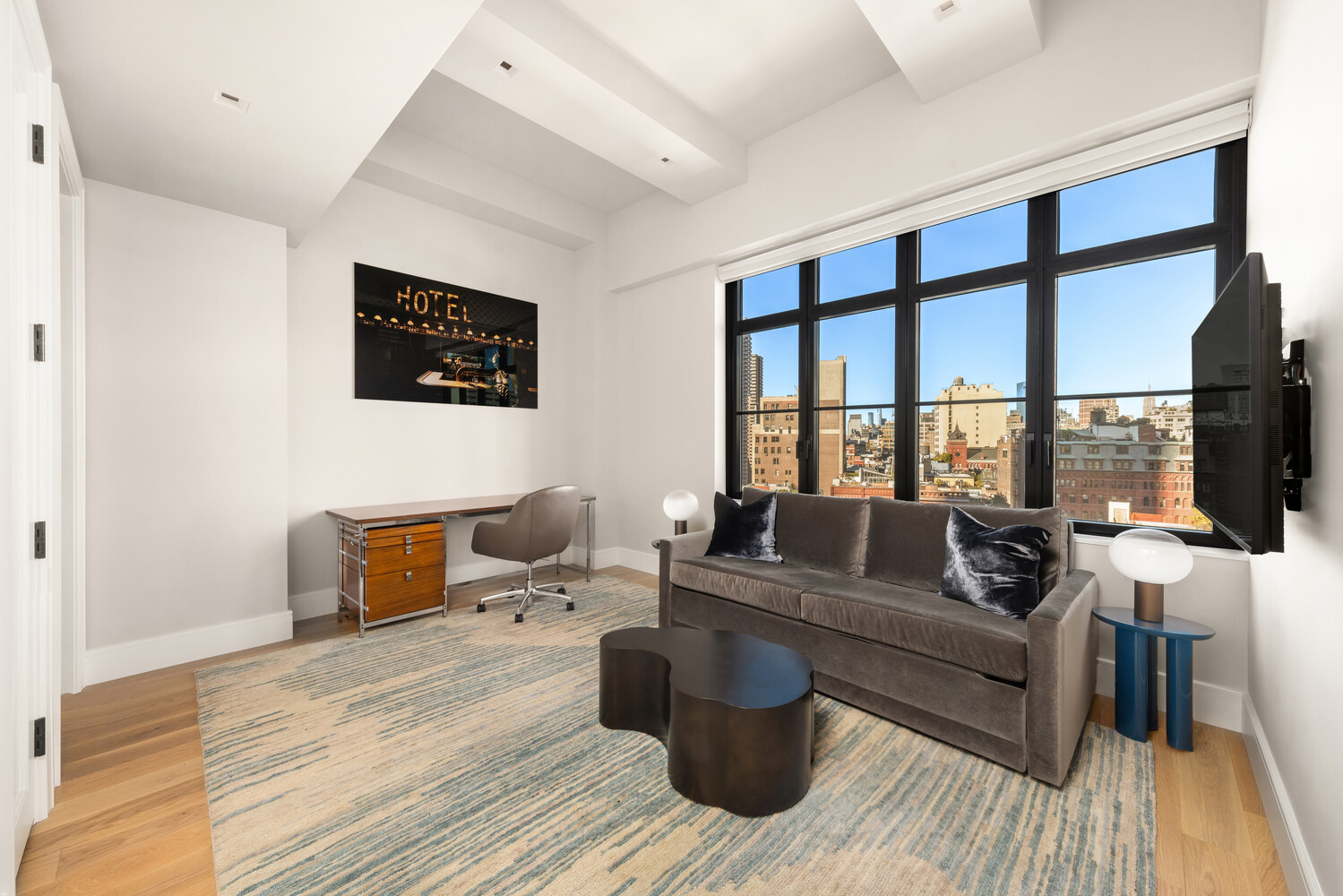 143 Reade Street, Unit 10A Manhattan, NY 10013 - Photo 9 of 18 a living room with furniture and a floor to ceiling window