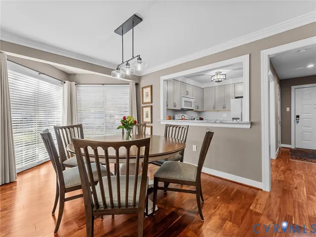 a view of a dining room with furniture window and wooden floor