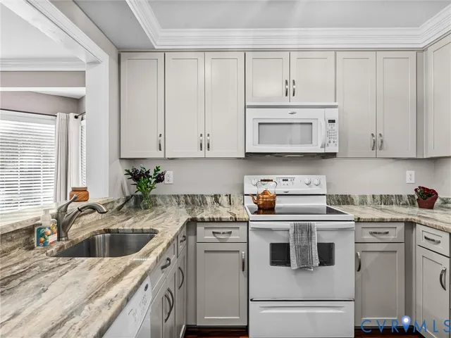 a kitchen with stainless steel appliances granite countertop a sink a stove and cabinets