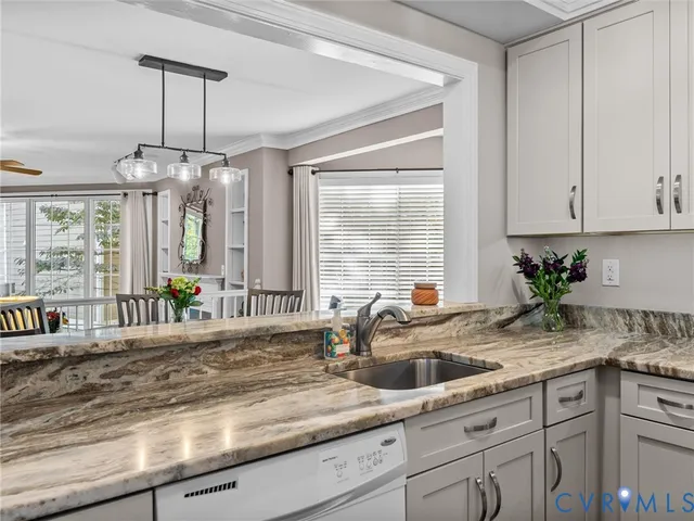 a kitchen with sink window and cabinets