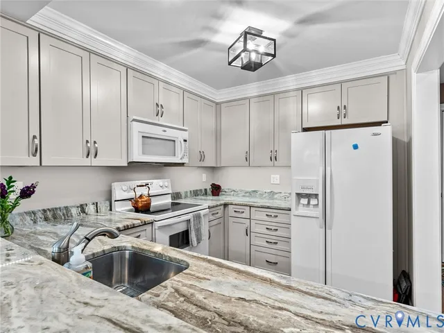 a kitchen with stainless steel appliances granite countertop a sink a stove and cabinets