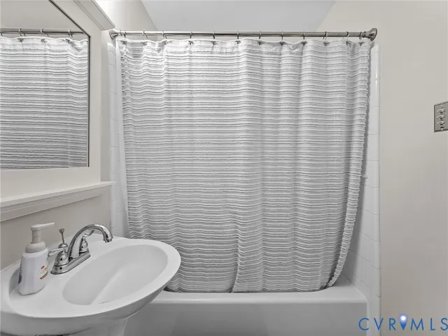 a bathroom with a shower curtain and a sink