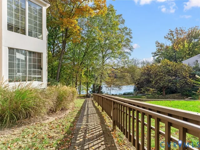 a view of a balcony with a yard