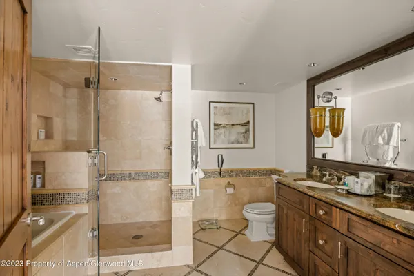 a spacious bathroom with a granite countertop sink toilet and shower
