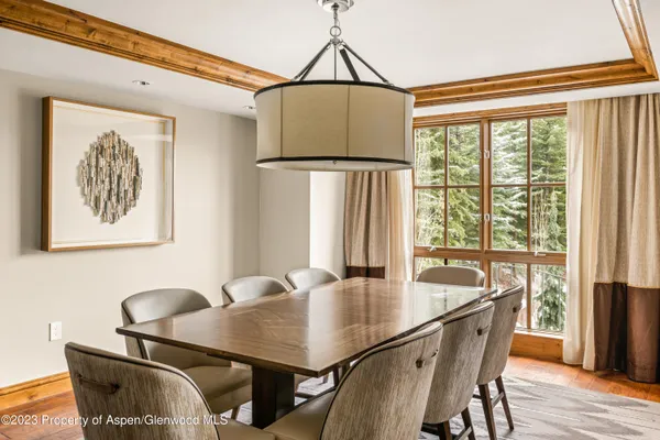 a dining room with furniture and wooden floor