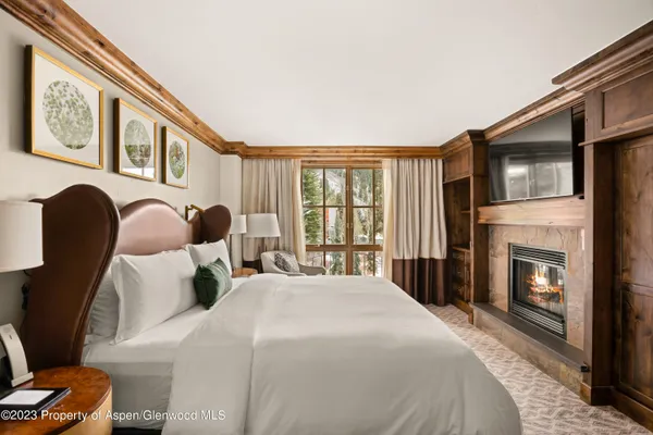 a bedroom with bed and a fireplace