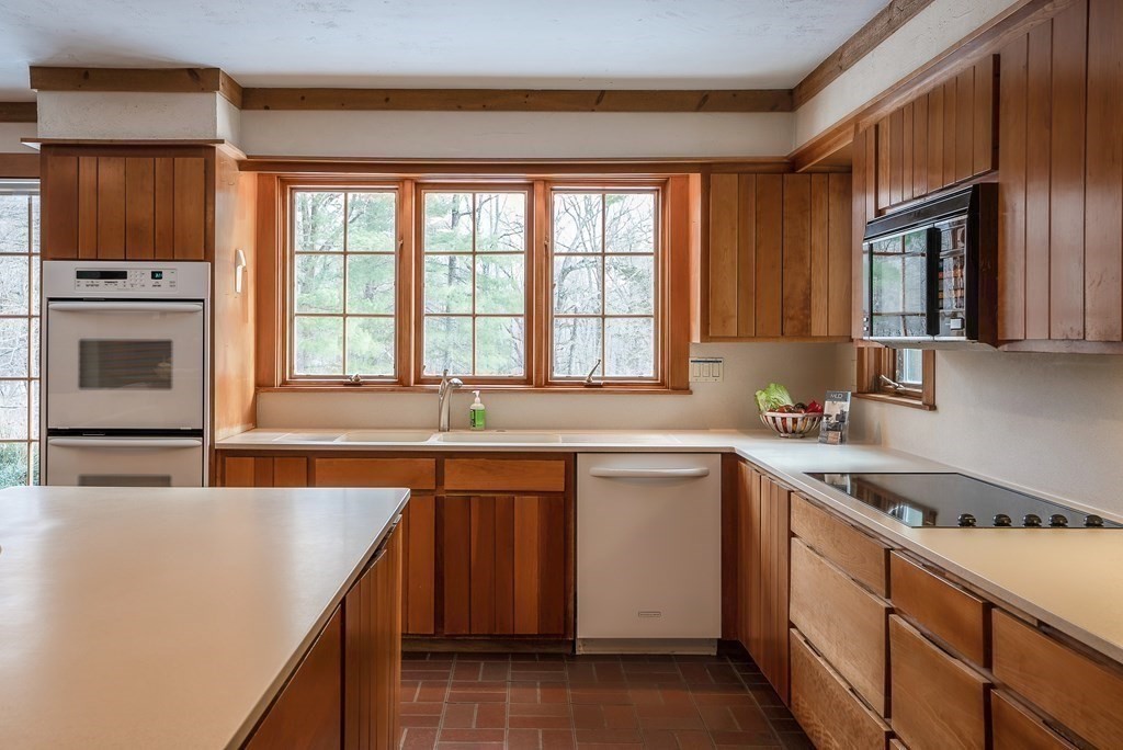 2 Sudbury Road Weston, MA 02493 - Photo 16 of 42 a kitchen with stainless steel appliances granite countertop a sink stove and refrigerator