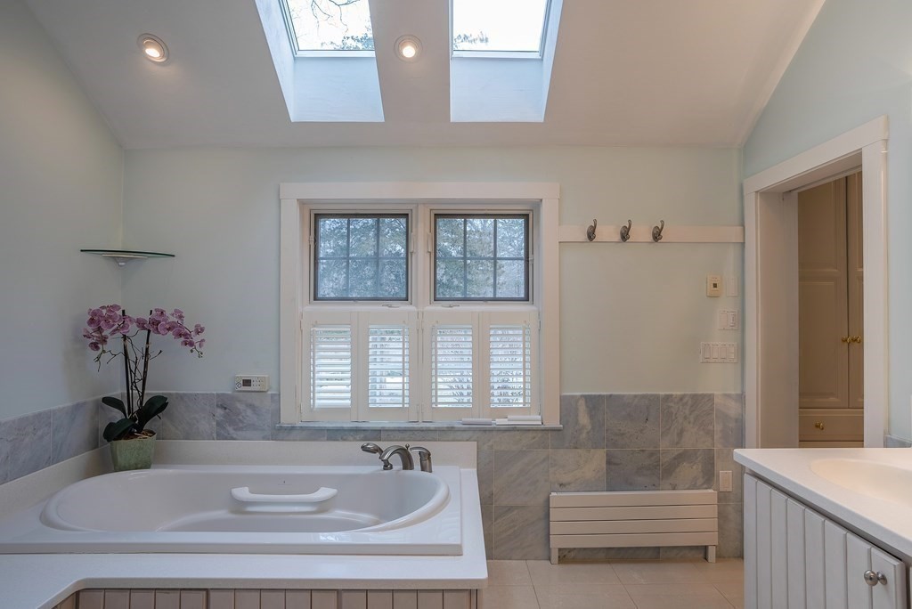 2 Sudbury Road Weston, MA 02493 - Photo 24 of 42 a bathroom with a tub sink and mirror
