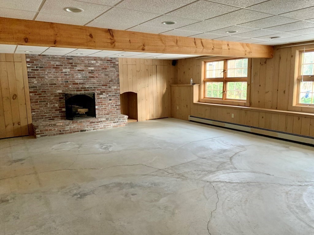 2 Sudbury Road Weston, MA 02493 - Photo 29 of 42 a view of an empty room with a fireplace and a window