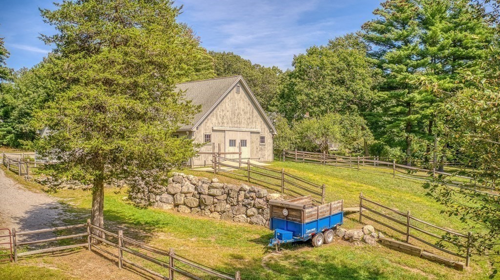 2 Sudbury Road Weston, MA 02493 - Photo 35 of 42 a view of a house with pool lawn chairs and a yard