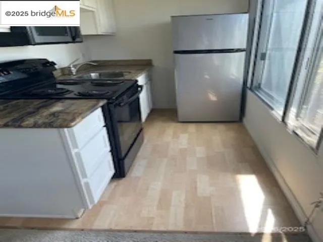 a kitchen with a refrigerator and a stove
