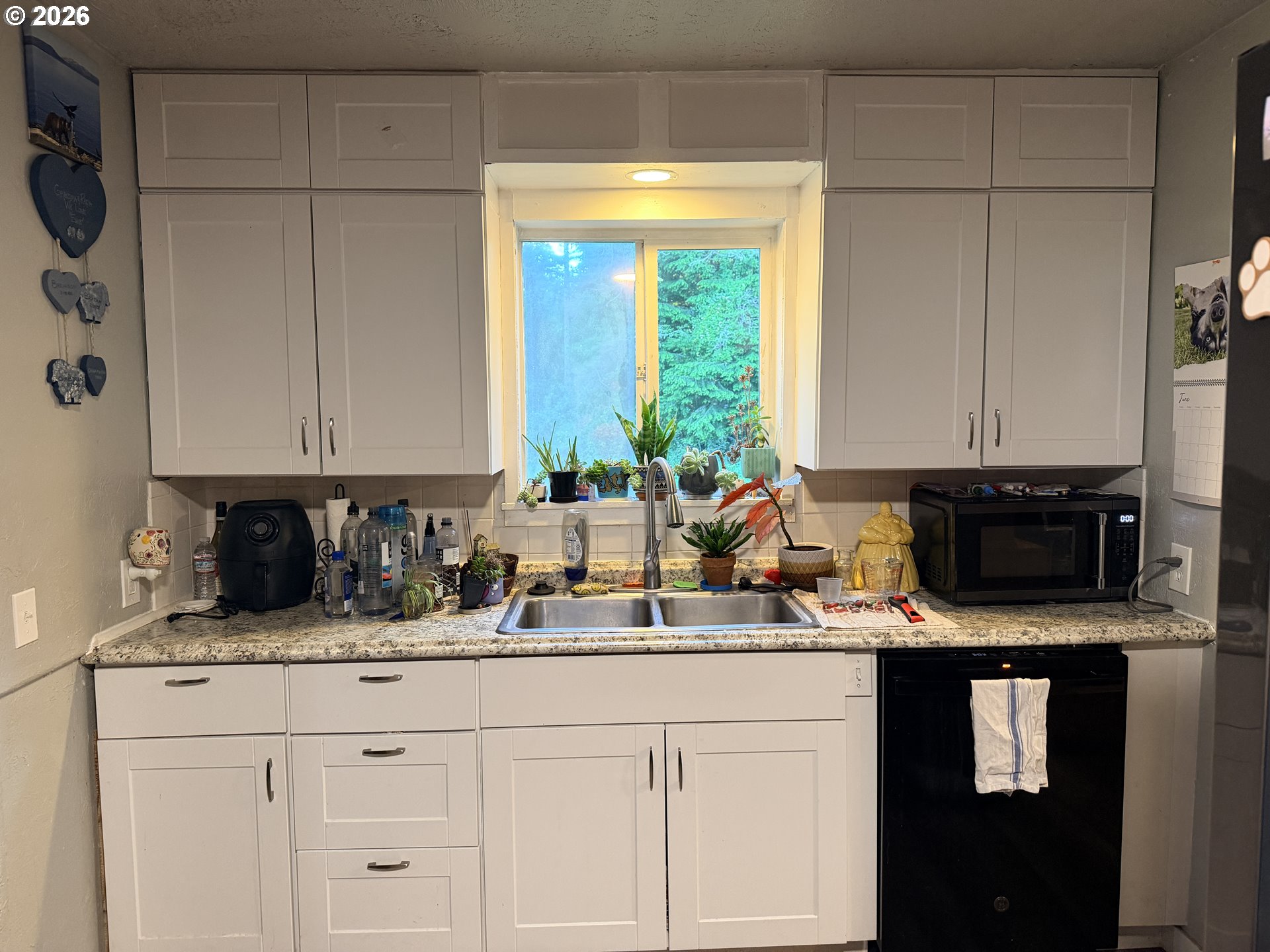 677 Southeast Moffitt Road Waldport, OR 97394 - Photo 14 of 36 a kitchen with a sink and cabinets