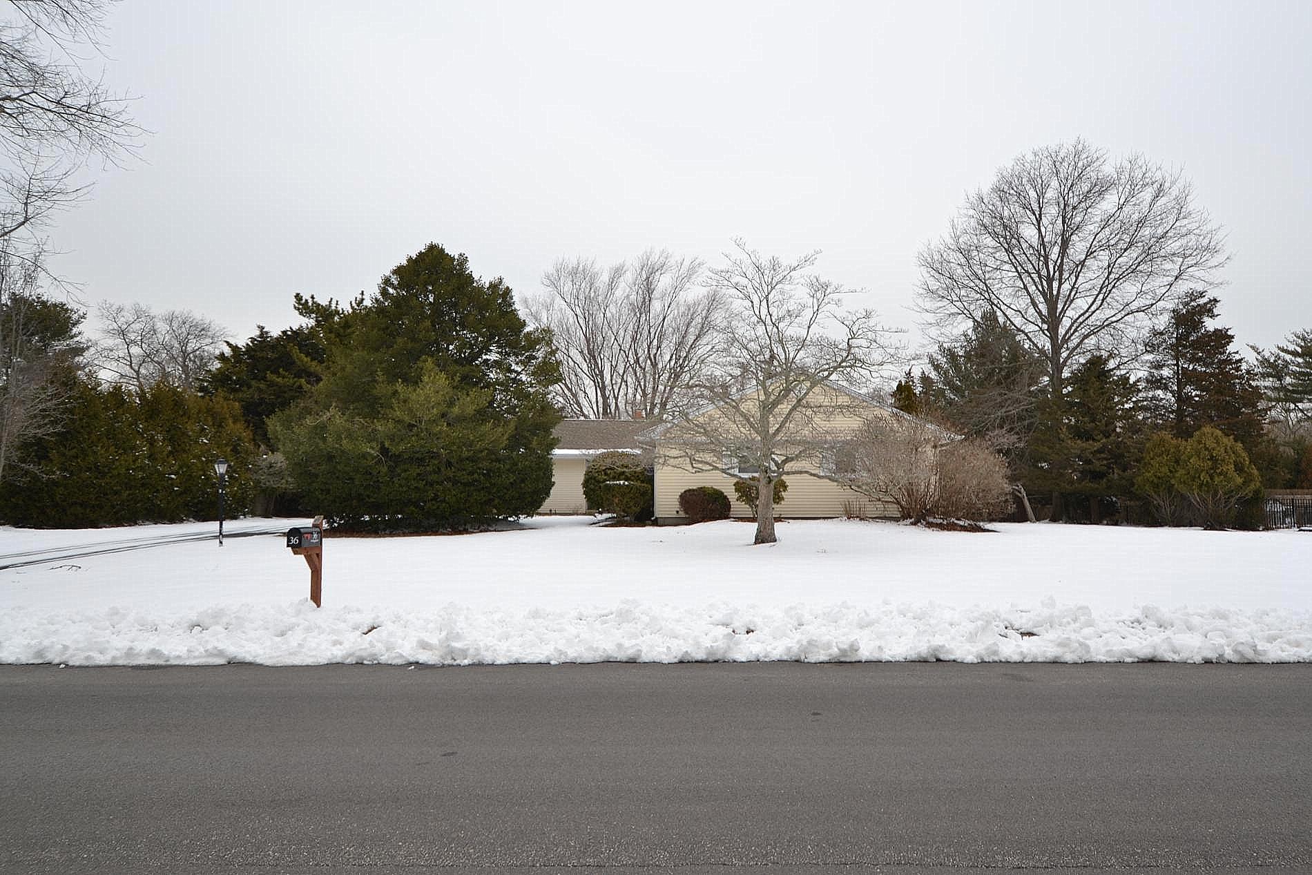 Snowy yard with a garage