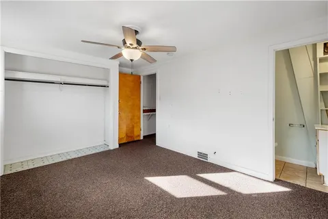 a view of an empty room with a ceiling fan