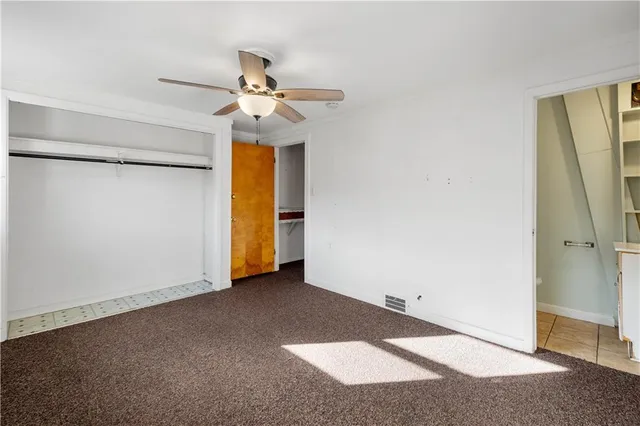 a view of an empty room with a ceiling fan