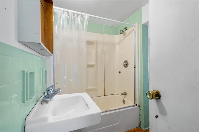 a bathroom with a bathtub and a shower