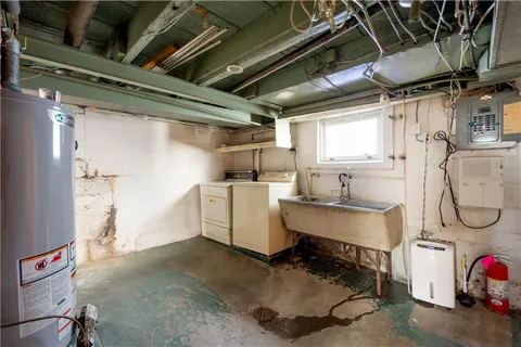 a utility room with cabinets dryer and washer
