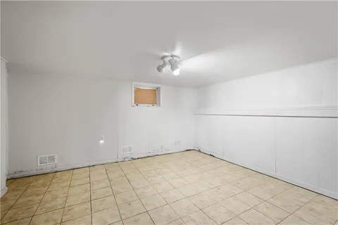 an empty room with a ceiling fan and carpet