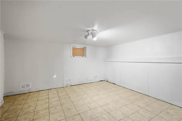 an empty room with a ceiling fan and carpet